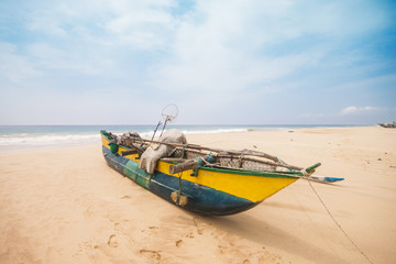 Fototapeta premium Traditional fishing boat on the beach. Shot in Sri Lanka.