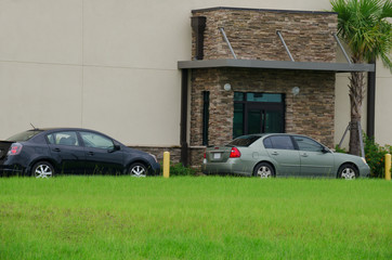 Generic drive thru pickup window with cars waiting in line to get their products or food - 117666902