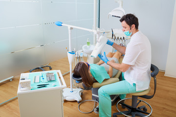 Teeth whitening in the dentist's office with professional equipm