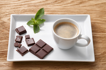 Espresso coffee with chocolate pieces on plate