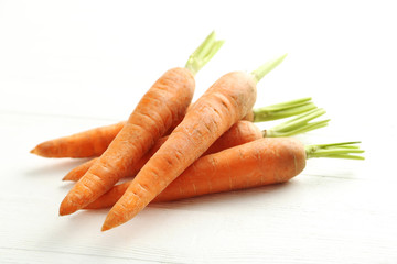 Fresh carrots on a white wooden table