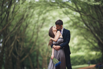 Handsome young couple posing outdoors after ceremony © olegparylyak