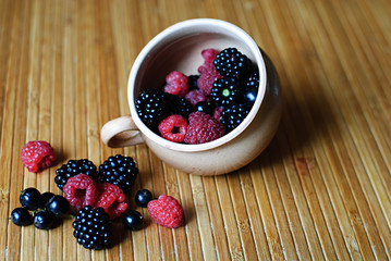 Blackberries, raspberries and currant on the table