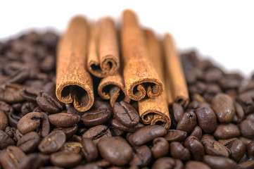 Obraz na płótnie Canvas Coffee beans and Cinnamon on the white background - isolated