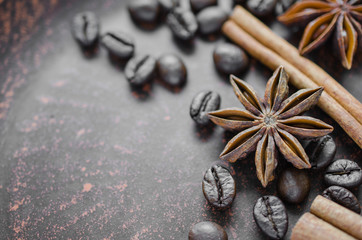 Coffee beans, cinnamon stick, star anise in a ceramic plate.