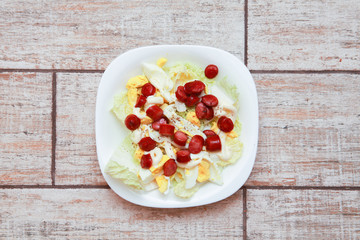 Fresh Greek salad in a bowl, top view