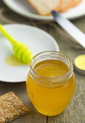 Honey in glass jar, closeup detail.