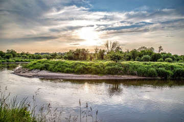 Summer landscape with river and sunset