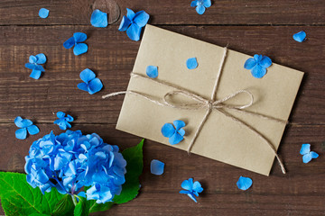 blue flowers of hydrangea with envelope, petals and copy space