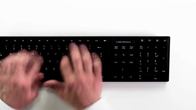 wireless keyboard top view,hands typing fast timelapse seen from above top view
