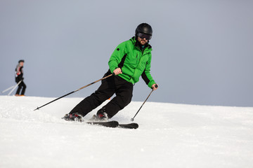 Male skier skiing on ski slope