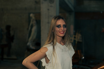 young woman in torn t shirt and heavy smeared mascara