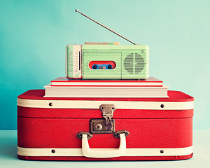 Vintage radio over books and suitcase