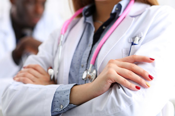 Fototapeta premium Female medicine doctor hands crossed on her chest in office