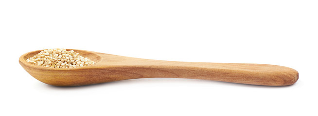 Spoon filled with quinoa seeds isolated