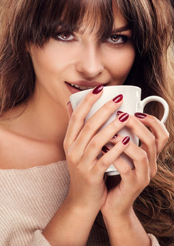 Pretty woman drinking coffee.