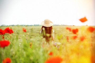 Beautiful girl in poppy field