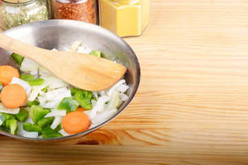 Vegetables and seasonings on wooden table.