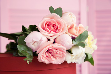 Beautiful bouquet of flowers on red gift box