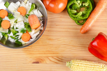 Vegetables and seasonings on wooden table.