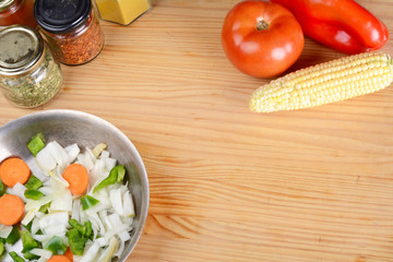 Vegetables and seasonings on wooden table.