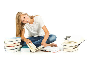 Young girl sitting on the floor reading over white background