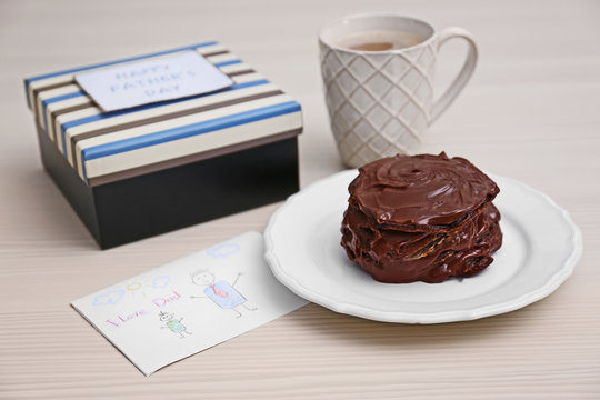 Chocolate pancakes with paint and coffee on table. Happy fathers day concept