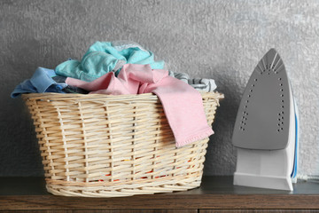 Clothes in wicker basket with iron
