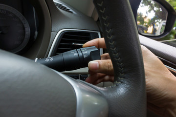man hand use the signal switch. Car interior detail