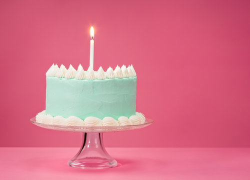 Blue Birthday Cake Over Pink Background.