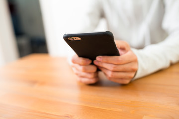 Woman using cellphone at home