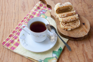 False stands on the tea cup near the sliced loaf