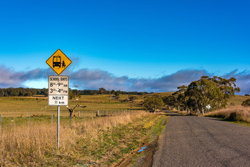 Australian outback road with school bus stop sign. Unmarked rural path. Myrtleville NSW, Australia