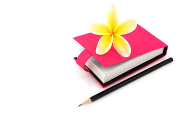 Blank note book with pencil and flower