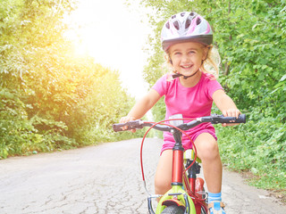 Happy child riding a bike in outdoor.