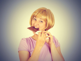 Portrait of young woman eat chocolate though.