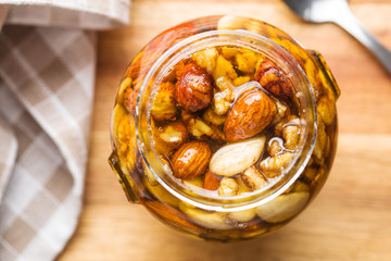 Honey and nuts in jar.
