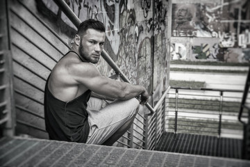 Fototapeta na wymiar Handsome Muscular Hunk Man Outdoor in City Setting. Showing Healthy Body While Looking Away