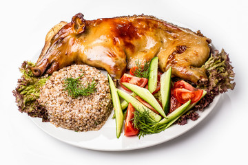 Roast suckling pig with buckwheat and fresh vegetables
