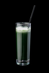 Cocktail of fresh herbs in a glass with a straw. On a black background