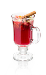 Stamp with slices of orange cardamom and cinnamon. In a glass beaker. On a white background