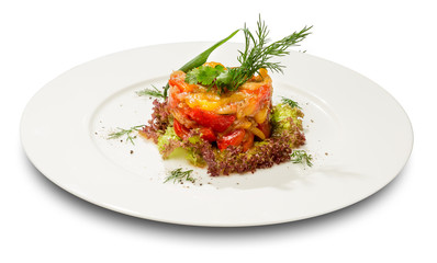 Vegetable stew on lettuce leaves. On a white plate and a white background