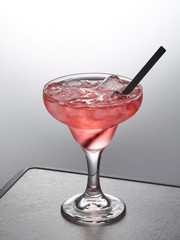 glass of pink iced cocktail