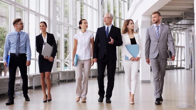 business people walking along office building 6
