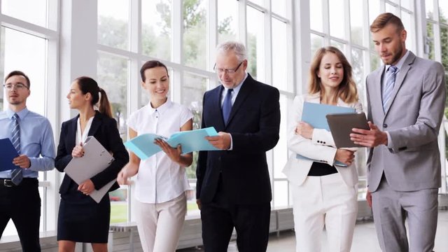 business people walking along office building 14