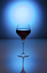 Bluewine3/A glass of red wine and grapes on a blue background