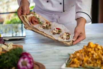 Pieces of meat with sauce. Sliced pear and chili peppers. Dish made by professional cook. New recipe of beef medallions.