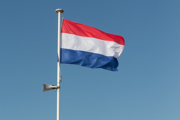 Fototapeta na wymiar Flag of France over a blue sky