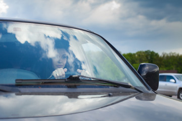 Fototapeta na wymiar The woman in a car