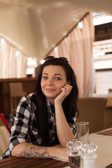 The woman is in a cafe